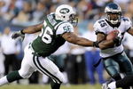 PHILADELPHIA - AUGUST 28: Lorenzo Booker #25 of the Philadelphia Eagles rushes as Vernon Gholston #56 of the New York Jets tries to make a tackle during a preseason game at Lincoln Financial Field on August 28, 2008 in Philadelphia, Pennsylvania. (Photo by Rob Tringali/Getty Images)