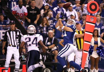 INDIANAPOLIS - NOVEMBER 02:  Anthony Gonzalez #11 of the Indianapolis Colts catches a 12-yard touchdown reception against Jonathan Wilhite #24 of the New England Patriots at Lucas Oil Stadium on November 2, 2008 in Indianapolis, Indiana.  (Photo by Andy Lyons/Getty Images)