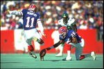 21 OCT 1990:  SCOTT NORWOOD #11, KICKER FOR THE BUFFALO BILLS, KICKS OFF AS CHRIS HALE HOLDS DURING THE BILLS 30-27 WIN OVER THE JETS ON A WINDY DAY AT RICH STADIUM IN ORCHARD PARK, NEW YORK.  MANDATORY CREDIT:  RICK STEWART/ALLSPORT