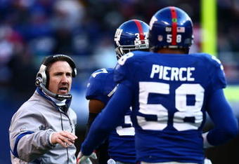 EAST RUTHERFORD, NJ - JANUARY 11:  Defensive corrdinator Steve Spagnuolo of the New York Giants talks with Aaron Pierce #58 during a break in play against the Philadelphia Eagles during the NFC Divisional Playoff Game on January 11, 2009 at Giants Stadium in East Rutherford, New Jersey.  (Photo by Chris McGrath/Getty Images)