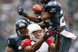 SEATTLE - DECEMBER 9:  Wide receiver Larry Fitzgerald #11 of the Arizona Cardinals fights to make a catch against Deon Grant #24 of the Seattle Seahawks at Qwest Field December 9, 2007 in Seattle, Washington. The ball fell incomplete. (Photo by Otto Greule Jr/Getty Images)