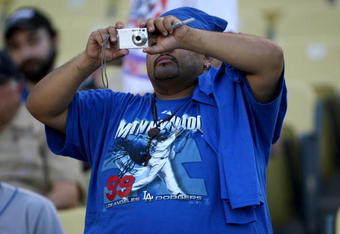 LOS ANGELES - MAY 7:  A fan wearing a Manny Ramirez tee shirt for takes a picture during pregame before the game between the Los Angeles Dodgers and the Washington Nationals on May 7, 2009 at Dodger Stadiium in Los Angeles, California.    (Photo by Stephen Dunn/Getty Images)