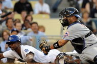 LOS ANGELES, CA - MAY 18: Juan Pierre #9 of the Los Angeles Dodgers slides in ahead of the tag of Ramon Castro #11 of the New York Mets to score a run for a 1-0 lead during the first inning at Dodger Stadium on May 18, 2009 in Los Angeles, California. (Photo by Harry How/Getty Images)