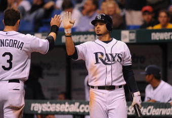 ST. PETERSBURG, FL - APRIL 30: Shortstop Jason Bartlett #8 of the Tampa Bay Rays celebrates a run by infielder Evan Longoria #3  against the Boston Red Sox April 30, 2009 at Tropicana Field in St. Petersburg, Florida.  (Photo by Al Messerschmidt/Getty Images)