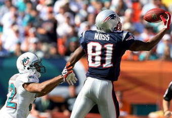 MIAMI - NOVEMBER 23: Wide receiver Randy Moss #81 of the New England Patriots pulls in a one-handed catch over cornerback Jason Allen #32 of the Miami Dolphins at Dolphin Stadium on November 23, 2008 in Miami, Florida.  (Photo by Doug Benc/Getty Images)