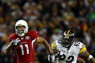 TAMPA, FL - FEBRUARY 01:  Larry Fitzgerald #11 of the Arizona Cardinals runs for a touchdown after a catch against James Harrison #92 of the Pittsburgh Steelers in the fourth quarter during Super Bowl XLIII on February 1, 2009 at Raymond James Stadium in Tampa, Florida.  (Photo by Chris McGrath/Getty Images)