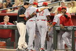 PHOENIX - MAY 12:  Joey Votto #19 of the Cincinnati Reds is helped off the field by manager Dusty Baker during the major league baseball game against the Arizona Diamondbacks at Chase Field on May 12, 2009 in Phoenix, Arizona.  (Photo by Christian Petersen/Getty Images)