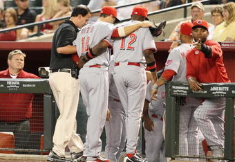 PHOENIX - MAY 12:  Joey Votto #19 of the Cincinnati Reds is helped off the field by manager Dusty Baker during the major league baseball game against the Arizona Diamondbacks at Chase Field on May 12, 2009 in Phoenix, Arizona.  (Photo by Christian Petersen/Getty Images)