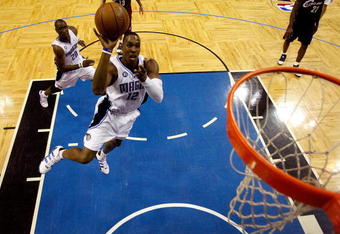 ORLANDO, FL - MAY 30: Dwight Howard #12 of the Orlando Magic drives to the hoop against the Cleveland Cavaliers in Game Six of the Eastern Conference Finals during the 2009 Playoffs at Amway Arena on May 30, 2009 in Orlando, Florida. NOTE TO USER: User expressly acknowledges and agrees that, by downloading and or using this photograph, User is consenting to the terms and conditions of the Getty Images License Agreement  (Photo by Scott Audette-Pool/Getty Images)