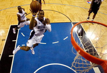 ORLANDO, FL - MAY 30: Dwight Howard #12 of the Orlando Magic drives to the hoop against the Cleveland Cavaliers in Game Six of the Eastern Conference Finals during the 2009 Playoffs at Amway Arena on May 30, 2009 in Orlando, Florida. NOTE TO USER: User expressly acknowledges and agrees that, by downloading and or using this photograph, User is consenting to the terms and conditions of the Getty Images License Agreement  (Photo by Scott Audette-Pool/Getty Images)