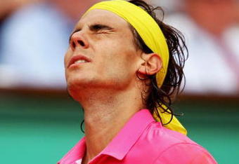 PARIS - MAY 31:  A dejected Rafael Nadal of Spain reacts as he heads towards defeat during the Men's Singles Fourth Round match against Robin Soderling of Sweden on day eight of the French Open at Roland Garros on May 31, 2009 in Paris, France.  (Photo by Clive Brunskill/Getty Images)