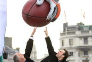 LONDON - OCTOBER 22:  Ken Livingstone and actor Christian Slater pose for photographers in front of a giant staute of aNFL Miami Dolphins Player 'Jason Taylor' to promotethe historic game between the Dolphins and New York Giants at Trafalgar square on 22 October, 2007 in London, England.  (Photo by MJ Kim/Getty Images)