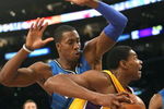 LOS ANGELES - JANUARY 16:  Andrew Bynum #17 of the Los Angeles Lakers drives baseline against Dwight Howard #12 of the Orlando Magic during their NBA game on January 16, 2009 at Staples Center in Los Angeles, California. The Magic won 109-103.   NOTE TO USER: User expressly acknowledges and agrees that, by downloading and/or using this Photograph, user is consenting to the terms and conditions of the Getty Images License Agreement. (Photo by Stephen Dunn/Getty Images)