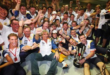 SINGAPORE - SEPTEMBER 28:  Renault F1 Team Principal Flavio Briatore (centre left) and Fernando Alonso (centre right) of Spain and Renault celebrate with team mates in the pitlane after Alonso won the Singapore Formula One Grand Prix at the Marina Bay Street Circuit on September 28, 2008 in Singapore.  The event is the first Formula One race to be held at night.  (Photo by Mark Thompson/Getty Images)