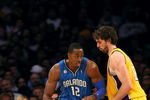 LOS ANGELES - JANUARY 16:  Dwight Howard #12 of the Orlando Magic dribbles the ball to the basket against Pau Gasol #16 of the Los Angeles Lakers during their NBA game on January 16, 2009 at Staples Center in Los Angeles, California. The Magic won 109-103.   NOTE TO USER: User expressly acknowledges and agrees that, by downloading and/or using this Photograph, user is consenting to the terms and conditions of the Getty Images License Agreement. (Photo by Stephen Dunn/Getty Images)es)