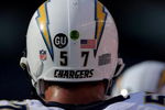 DENVER - SEPTEMBER 14:  Linebacker Matt Wilhelm #57 of the San Diego Chargers defends against the Denver Broncos during NFL action at Invesco Field at Mile High on September 14, 2008 in Denver, Colorado. The green dot on Wilhelm's helmet denotes the content of a radio device to communicate with his coaches. The Broncos defeated the Chargers 39-38.  (Photo by Doug Pensinger/Getty Images)