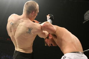 UNCASVILLE, CT - MAY 16:  Dan Miller (White Trunks) receives a blow from Ryan McGivern (Black Trucks) of the Miletech Fighting System during their bout presented by the International Fighting League at the Mohegan Sun Arena May 16, 2008 in Uncasville, Connecticut.  (Photo by Al Bello/Getty Images)