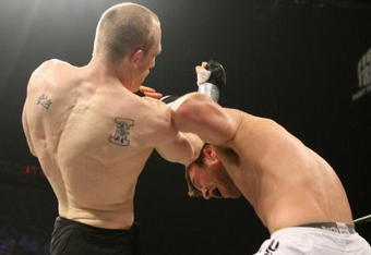 UNCASVILLE, CT - MAY 16:  Dan Miller (White Trunks) receives a blow from Ryan McGivern (Black Trucks) of the Miletech Fighting System during their bout presented by the International Fighting League at the Mohegan Sun Arena May 16, 2008 in Uncasville, Connecticut.  (Photo by Al Bello/Getty Images)