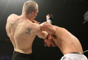 UNCASVILLE, CT - MAY 16:  Dan Miller (White Trunks) receives a blow from Ryan McGivern (Black Trucks) of the Miletech Fighting System during their bout presented by the International Fighting League at the Mohegan Sun Arena May 16, 2008 in Uncasville, Connecticut.  (Photo by Al Bello/Getty Images)