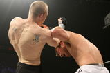 UNCASVILLE, CT - MAY 16:  Dan Miller (White Trunks) receives a blow from Ryan McGivern (Black Trucks) of the Miletech Fighting System during their bout presented by the International Fighting League at the Mohegan Sun Arena May 16, 2008 in Uncasville, Connecticut.  (Photo by Al Bello/Getty Images)
