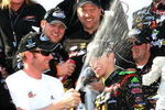 DOVER, DE - MAY 30: Dale Earnhardt Jr (3L), team owner of the #88 GoDaddy.com Chevrolet driven by Brad Kesleowski (C) sprays champagne in the victory lane during celebration for the NASCAR Nationwide Series Heluva Good! 200 at Dover International Speedway on May 30, 2009 in Dover, Delaware.  (Photo by Jerry Markland/Getty Images for NASCAR)