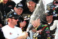 DOVER, DE - MAY 30: Dale Earnhardt Jr (3L), team owner of the #88 GoDaddy.com Chevrolet driven by Brad Kesleowski (C) sprays champagne in the victory lane during celebration for the NASCAR Nationwide Series Heluva Good! 200 at Dover International Speedway on May 30, 2009 in Dover, Delaware.  (Photo by Jerry Markland/Getty Images for NASCAR)
