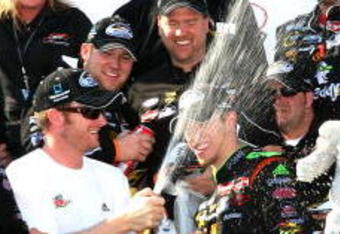 DOVER, DE - MAY 30: Dale Earnhardt Jr (3L), team owner of the #88 GoDaddy.com Chevrolet driven by Brad Kesleowski (C) sprays champagne in the victory lane during celebration for the NASCAR Nationwide Series Heluva Good! 200 at Dover International Speedway on May 30, 2009 in Dover, Delaware.  (Photo by Jerry Markland/Getty Images for NASCAR)