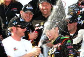 DOVER, DE - MAY 30: Dale Earnhardt Jr (3L), team owner of the #88 GoDaddy.com Chevrolet driven by Brad Kesleowski (C) sprays champagne in the victory lane during celebration for the NASCAR Nationwide Series Heluva Good! 200 at Dover International Speedway on May 30, 2009 in Dover, Delaware.  (Photo by Jerry Markland/Getty Images for NASCAR)