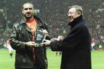 10 Apr 2001:  Former legend and crowd favourite Eric Cantona receives his award of best ever Manchester United player from Manchester United manager Alex Ferguson before the FA Carling Premiership match against Charlton Athletic played at Old Trafford, in Manchester, England. Manchester United won the match 2-1. \ Mandatory Credit: Laurence Griffiths /Allsport