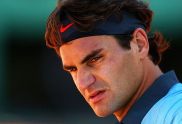 PARIS - MAY 30:  Roger Federer of Switzerland looks on during the Men's Third Round match against Paul-Henri Mathieu of France on day seven of the French Open at Roland Garros on May 30, 2009 in Paris, France.  (Photo by Clive Brunskill/Getty Images)