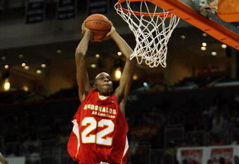 CORAL GABLES, FL - APRIL 01:  John Henson #22 of the West Team dunks over Dexter Strickland #7 of the East Team in the 2009 McDonald's All American Men's High School Basketball Game at BankUnited Center on April 1, 2009 in Coral Gables, Florida.  (Photo by Doug Benc/Getty Images)