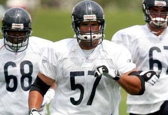 BOURBONNAIS, IL - JULY 27: Offensive lineman Olin Kreutz #57, Anthony Oakley #68 and Travis Leffew #67 of the Chicago Bears work out during the first summer training camp practice on July 27, 2006 at Olivet Nazarene University in Bourbonnais, Illinois.  (Photo by Jonathan Daniel/Getty Images)