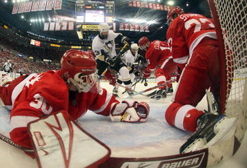 DETROIT - MAY 31:  Chris Osgood #30, and Brad Stuart #23 of the Detroit Red Wings defend the net against Bill Guerin #13 of the Pittsburgh Penguins during Game Two of the 2009 Stanley Cup Finals at Joe Louis Arena on May 31, 2009 in Detroit, Michigan.  (Photo by Jim McIsaac/Getty Images)