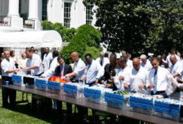 WASHINGTON - MAY 21:  U.S. President Barack Obama (4th-R) helps to assemble care packages with Pittsburgh Steelers wide receiver Hines Ward (5th-R) and Sen. Arlen Specter (D-PA) (3rd-R) on the South Lawn of the White House May 21, 2009 in Washington, DC. Obama hosted the Super Bowl Champion Pittsburgh Steelers and wounded warriors from Walter Reed Army Medical Center and National Naval Medical Center with their families in conjunction with packing care packages for troops serving in Iraq and Afghanistan.  (Photo by Alex Wong/Getty Images)