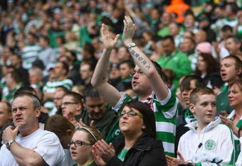 GLASGOW, UNITED KINGDOM - MAY 24:  Celtic fans cheers on their team during the Scottish Premier League match between Celtic and Hearts at Parkhead on May 24, 2009 in Glasgow, Scotland.  (Photo by Tom Shaw/Getty Images)