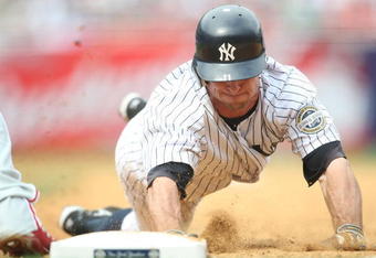 NEW YORK - MAY 24:  Brett Gardner #11 of the New York Yankees dives back into first against the Philadelphia Phillies on May 24, 2009 at Yankee Stadium in the Bronx borough of New York City.  (Photo by Nick Laham/Getty Images)