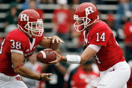 PISCATAWAY, NJ - SEPTEMBER 27: Quarterback Mike Teel #14 of the Rutgers Scarlet Knights hands off to running back Joe Martinek #38 during the first quarter against the Morgan State Bears at Rutgers Stadium on September 27, 2008 in Piscataway, New Jersey. (Photo by Jarrett Baker/Getty Images)