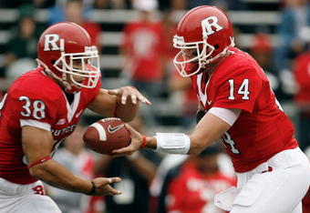 PISCATAWAY, NJ - SEPTEMBER 27:  Quarterback Mike Teel #14 of the Rutgers Scarlet Knights hands off to running back Joe Martinek #38 during the first quarter against the Morgan State Bears at Rutgers Stadium on September 27, 2008 in Piscataway, New Jersey.  (Photo by Jarrett Baker/Getty Images)
