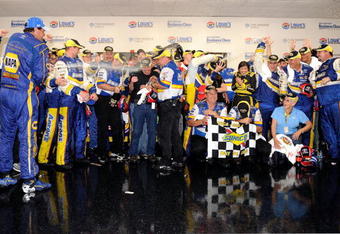CONCORD, NC - MAY 25:  Team owner Michael Waltrip (L), driver of the #55 NAPA Auto Parts Toyota, and David Reutimann (C), driver of the #00 Aaron's Dream Machine Toyota, celebrate in victory lane after winning the NASCAR Sprint Cup Series Coca-Cola 600 on May 25, 2009 at Lowe's Motor Speedway in Concord, North Carolina. Reutimann won the Coca-Cola 600 due to a rain out on lap 227.  (Photo by John Harrelson/Getty Images)