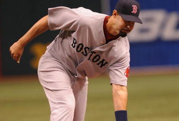 ST. PETERSBURG, FL - APRIL 30: Infielder Mike Lowell #25 of the  Boston Red Sox bobbles a short hit down the third baseline against the Tampa Bay Rays April 30, 2009 at Tropicana Field in St. Petersburg, Florida.  (Photo by Al Messerschmidt/Getty Images)