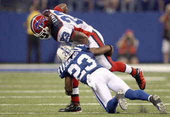 INDIANAPOLIS - AUGUST 24: Marshawn Lynch #23 of the Buffalo Bills carries the ball as he is tackled by Tim Jennings #23 of the Indianapolis Colts at Lucas Oil Stadium on August 24, 2008 in Indianapolis, Indiana. The Bills defeated the Colts 20-7.  (Photo by Jonathan Daniel/Getty Images)
