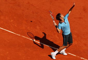 PARIS - JUNE 01:  Roger Federer of Switzerland serves during the Men's Singles Fourth Round match against Tommy Haas of Germany on day nine of the French Open at Roland Garros on June 1, 2009 in Paris, France.  (Photo by Clive Brunskill/Getty Images)