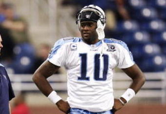 DETROIT , MI - NOVEMBER 27: Vince Young #10 of the Tennessee Titans talks with head coach Jeff Fisher, offensive coordinator Mike Heimerdinger and trainer Brad Brown after coming in the game in the fourth quarter against the Detroit Lions on November 27, 2008 at Ford Field in Detroit, Michigan.  (Photo by Gregory Shamus/Getty Images)