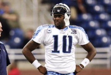 DETROIT , MI - NOVEMBER 27: Vince Young #10 of the Tennessee Titans talks with head coach Jeff Fisher, offensive coordinator Mike Heimerdinger and trainer Brad Brown after coming in the game in the fourth quarter against the Detroit Lions on November 27, 2008 at Ford Field in Detroit, Michigan.  (Photo by Gregory Shamus/Getty Images)