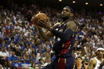 ORLANDO, FL - MAY 30: LeBron James #23 of the Cleveland Cavaliers drives to the hoop over Mickael Pietrus #20 of the Orlando Magic in Game Six of the Eastern Conference Finals during the 2009 Playoffs at Amway Arena on May 30, 2009 in Orlando, Florida. NOTE TO USER: User expressly acknowledges and agrees that, by downloading and or using this photograph, User is consenting to the terms and conditions of the Getty Images License Agreement  (Photo by Elsa/Getty Images)