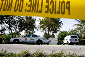MIAMI - NOVEMBER 26:  Police cars are seen in front of the home where an intruder shot Washington Redskins football player Sean Taylor in the leg November 26, 2007 in Miami, Florida. The police continue to investigate what happened during the shooting around 1:45 in the morning at the home in the Miami suburb of Palmetto Bay.  (Photo by Joe Raedle/Getty Images)