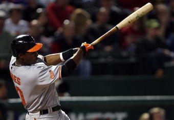 ARLINGTON, TX - APRIL 13:  Adam Jones #10 of the Baltimore Orioles hits a RBI double against the Texas Rangers in the fourth inning on April 13, 2009 at Rangers Ballpark in Arlington, Texas.  (Photo by Ronald Martinez/Getty Images)