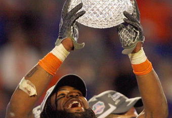 MIAMI - JANUARY 08:  Brandon Spikes #51 of the Florida Gators holds up the winning trophy after the FedEx BCS National Championship Game against the Oklahoma Sooners at Dolphin Stadium on January 8, 2009 in Miami, Florida.  (Photo by Eliot J. Schechter/Getty Images)