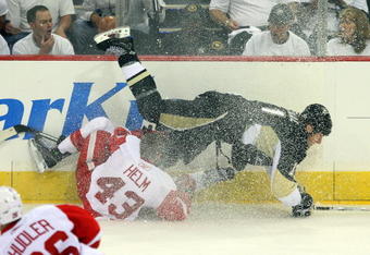 PITTSBURGH - JUNE 02:  Darren Helm #43 of the Detroit Red Wings trips up Jordan Staal #11 of the Pittsburgh Penguins during Game Three of the 2009 NHL Stanley Cup Finals on June 2, 2009 at Mellon Arena in Pittsburgh, Pennsylvania.  (Photo by Jim McIsaac/Getty Images)