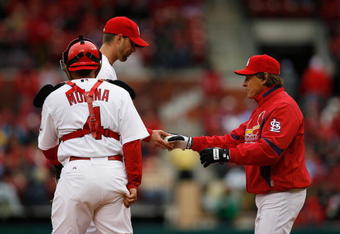 ST. LOUIS - APRIL 6:  Manager Tony La Russa takes the ball from pitcher Adam Wainwright #50 of the St. Louis Cardinals as catcher Yadier Molina looks on against the Pittsburgh Pirates during Opening Day on April 6, 2009 at Busch Stadium in St. Louis, Missouri.  The Pirates beat the Cardinals 6-4. (Photo by Dilip Vishwanat/Getty Images)  